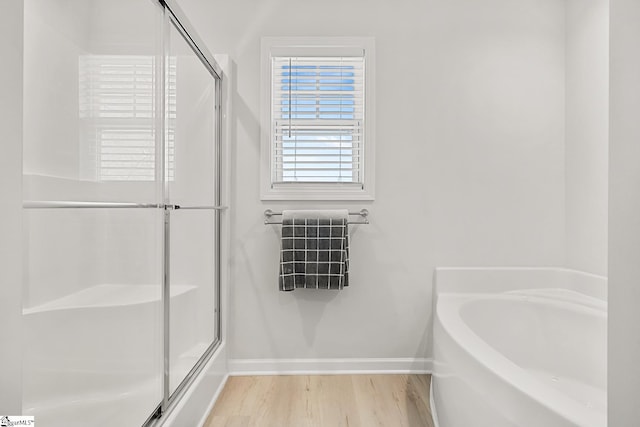 121 Frost Flower Way, Fountain Inn, SC 29644 - full bathroom featuring baseboards, a shower stall, wood finished floors, and a garden tub