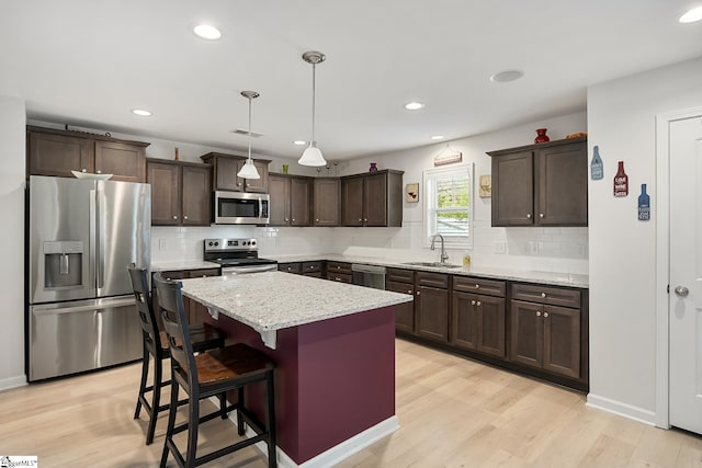 121 Frost Flower Way, Fountain Inn, SC 29644 - kitchen with appliances with stainless steel finishes, a sink, dark brown cabinets, backsplash, and recessed lighting