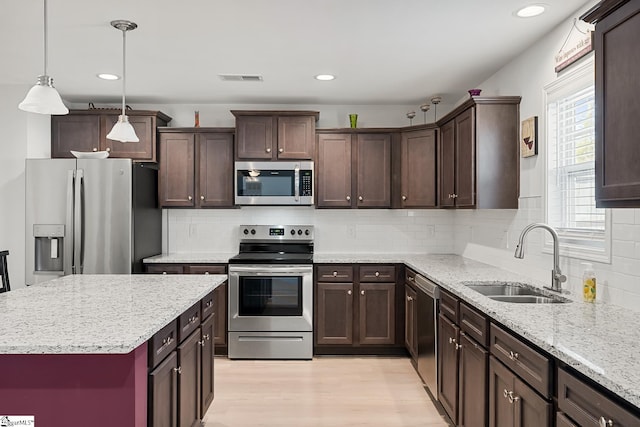 121 Frost Flower Way, Fountain Inn, SC 29644 - kitchen with appliances with stainless steel finishes, a sink, dark brown cabinetry, light wood-style flooring, and recessed lighting