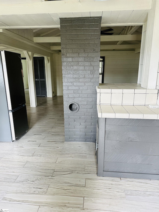 detailed view of freestanding refrigerator and wood finished floors