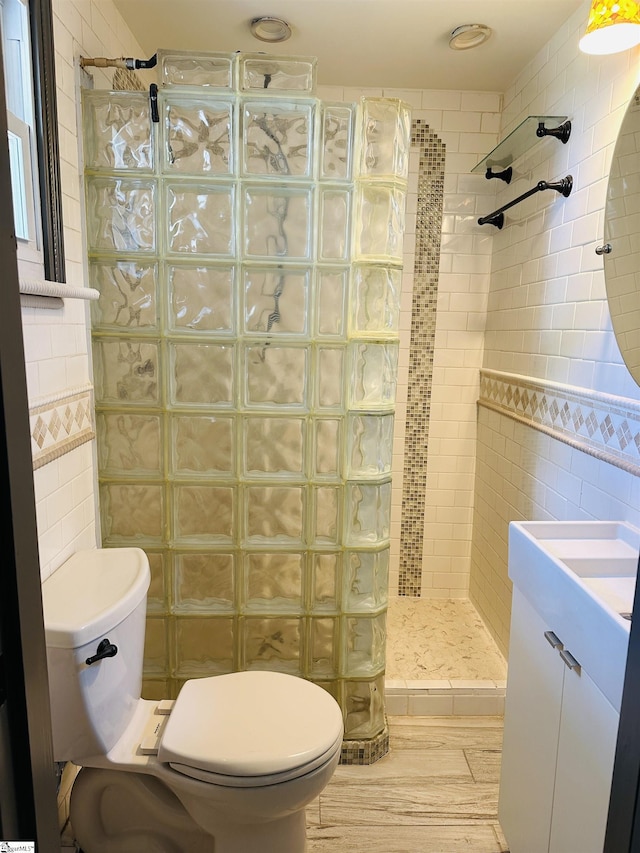 bathroom featuring tile walls, a walk in shower, and toilet
