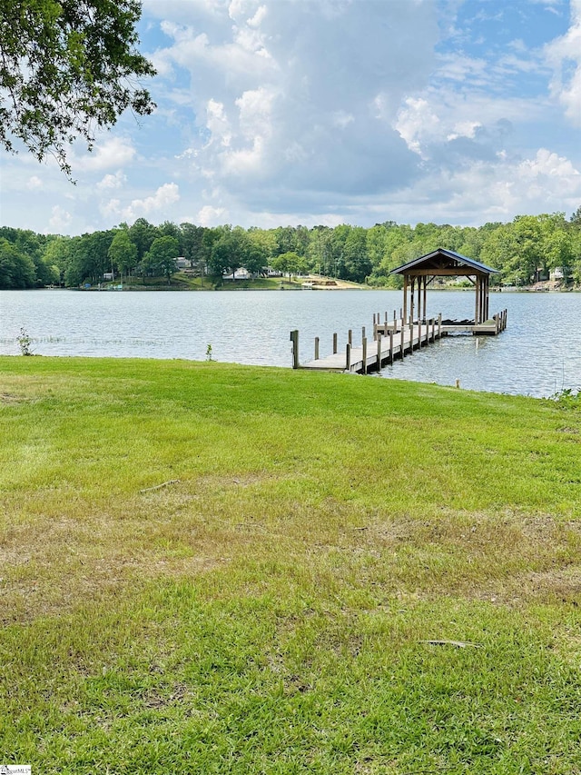 dock area featuring a yard and a water view