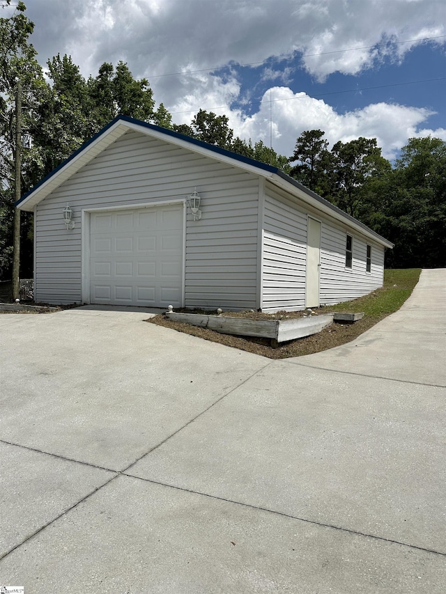 detached garage with concrete driveway