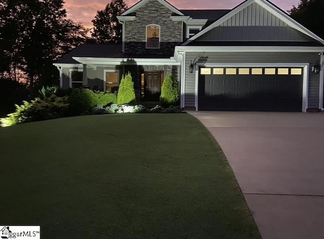 31 Goodwin Farms Ct, Travelers Rest, SC 29690 - craftsman-style home with driveway, a garage, stone siding, a front yard, and board and batten siding