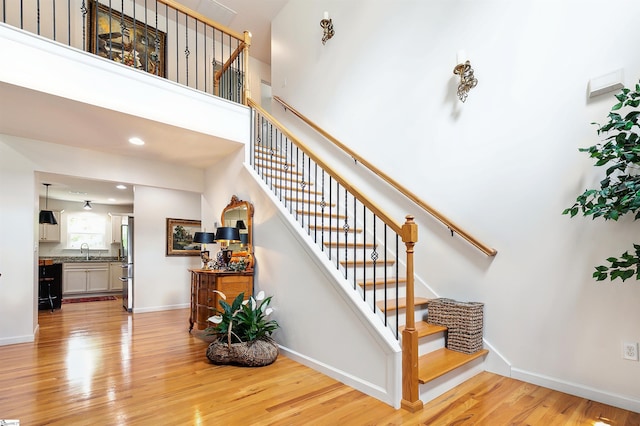 31 Goodwin Farms Ct, Travelers Rest, SC 29690 - staircase featuring wood finished floors, baseboards, a high ceiling, and recessed lighting