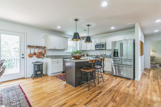 31 Goodwin Farms Ct, Travelers Rest, SC 29690 - kitchen featuring stainless steel appliances, light wood-type flooring, a breakfast bar area, a kitchen island, and recessed lighting