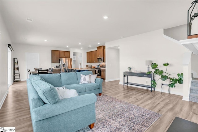 204 Hazelcroft Dr, Fountain Inn, SC 29644 - living area featuring light wood-type flooring, baseboards, recessed lighting, and stairway