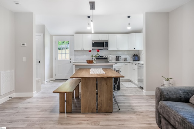 11 Adger St, Pelzer, SC 29669 - kitchen featuring appliances with stainless steel finishes, light countertops, white cabinets, tasteful backsplash, and baseboards