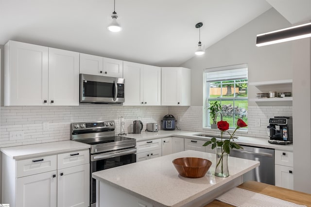 11 Adger St, Pelzer, SC 29669 - kitchen with appliances with stainless steel finishes, a sink, backsplash, lofted ceiling, and white cabinetry