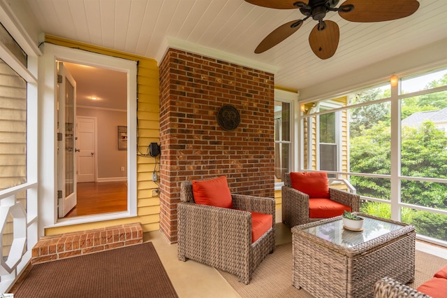 sunroom / solarium featuring ceiling fan