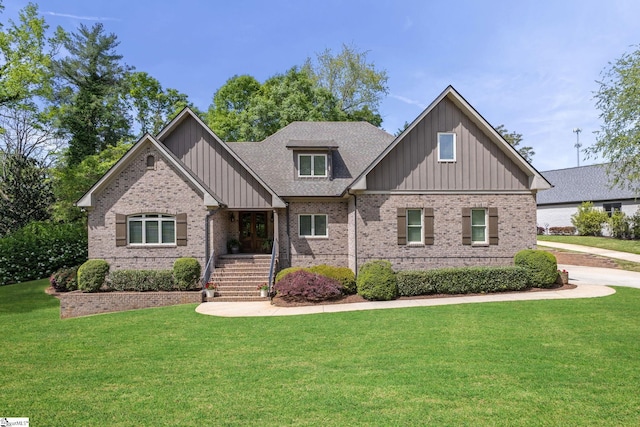 15 Paddington Ave, Greenville, SC 29609 - craftsman-style house featuring board and batten siding, brick siding, a front yard, and roof with shingles