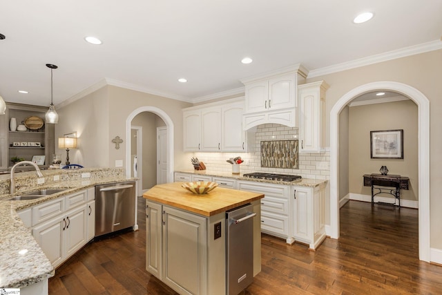15 Paddington Ave, Greenville, SC 29609 - kitchen featuring a sink, stainless steel appliances, arched walkways, wood counters, and decorative backsplash