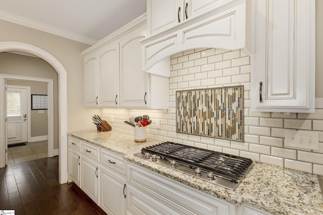 15 Paddington Ave, Greenville, SC 29609 - kitchen featuring stainless steel gas stovetop, arched walkways, tasteful backsplash, baseboards, and dark wood-style floors