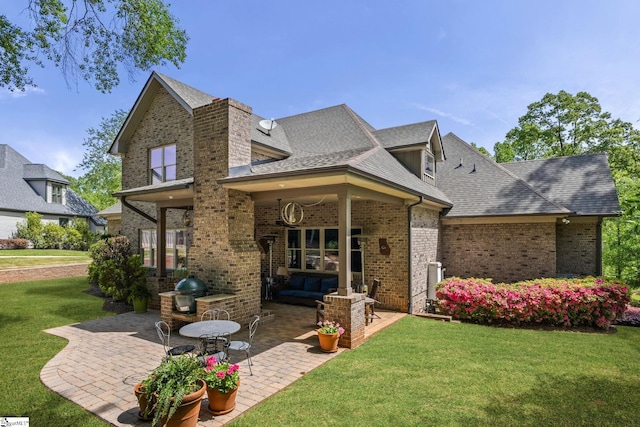 15 Paddington Ave, Greenville, SC 29609 - rear view of house featuring a patio area, brick siding, a lawn, and roof with shingles