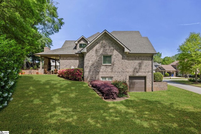 15 Paddington Ave, Greenville, SC 29609 - view of front of home featuring brick siding, a garage, a front lawn, and a chimney