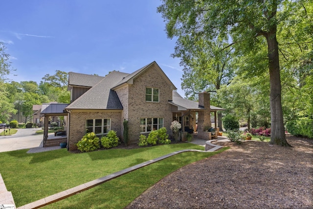 15 Paddington Ave, Greenville, SC 29609 - back of property featuring brick siding, a yard, a shingled roof, and a chimney