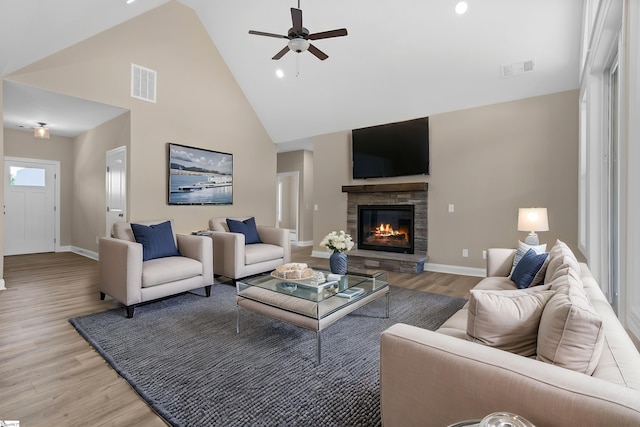 21 Old American Blvd, Pendleton, SC 29670 - living room featuring high vaulted ceiling, light wood-style flooring, a stone fireplace, a ceiling fan, and baseboards