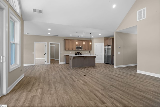 21 Old American Blvd, Pendleton, SC 29670 - kitchen with appliances with stainless steel finishes, open floor plan, wood finished floors, a center island with sink, and baseboards