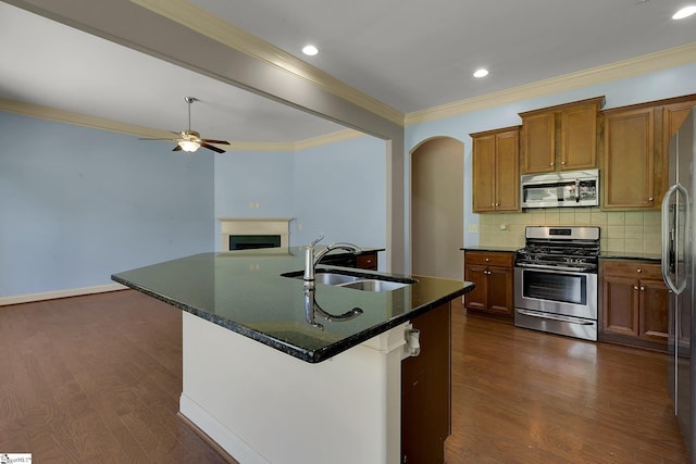 9 Sheldrake Pl, Simpsonville, SC 29681 - kitchen with appliances with stainless steel finishes, a sink, a fireplace, dark wood-style flooring, and ornamental molding