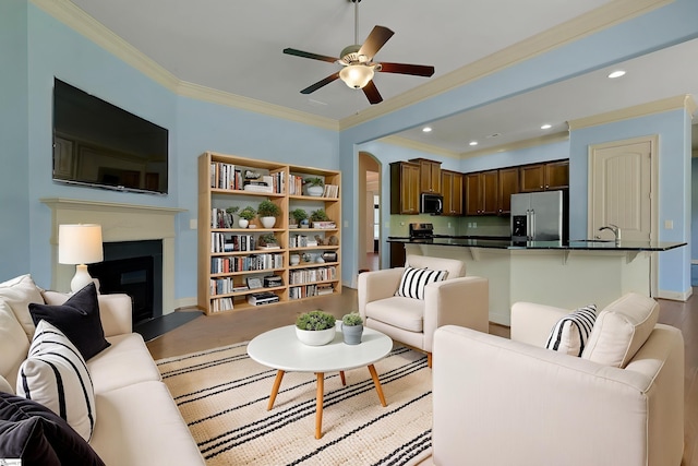 9 Sheldrake Pl, Simpsonville, SC 29681 - living room with ceiling fan, a fireplace, ornamental molding, recessed lighting, and light wood-style flooring