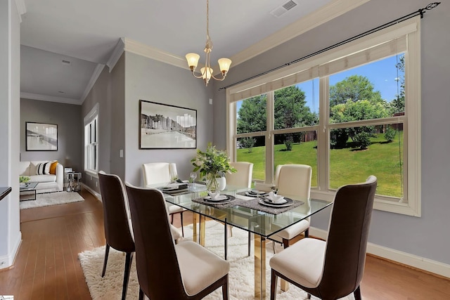 9 Sheldrake Pl, Simpsonville, SC 29681 - dining area featuring crown molding, a chandelier, baseboards, and wood-type flooring