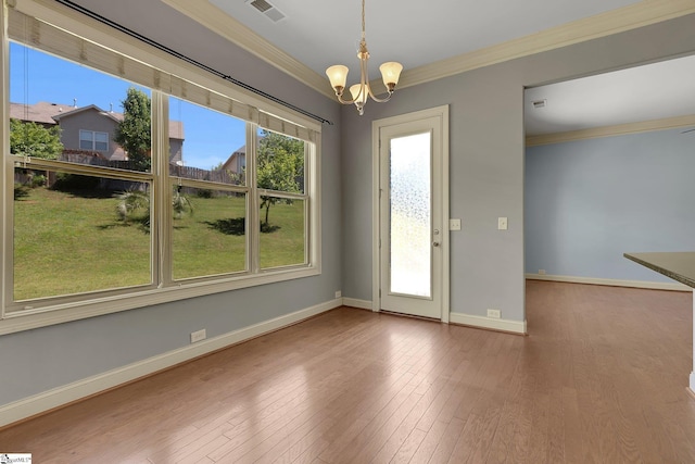 9 Sheldrake Pl, Simpsonville, SC 29681 - unfurnished dining area with a chandelier, ornamental molding, wood finished floors, and baseboards