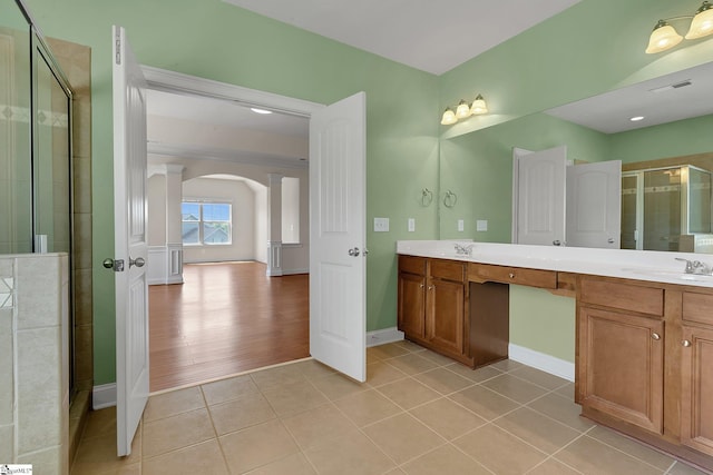 9 Sheldrake Pl, Simpsonville, SC 29681 - bathroom featuring decorative columns, a shower stall, double vanity, tile patterned floors, and baseboards