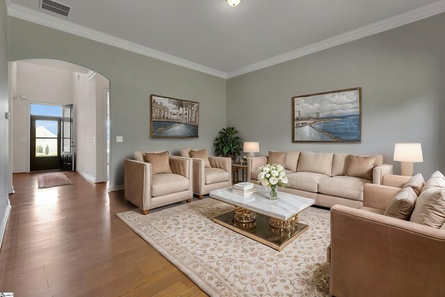 9 Sheldrake Pl, Simpsonville, SC 29681 - living room with arched walkways, crown molding, wood finished floors, and baseboards