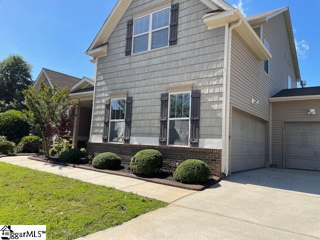 9 Sheldrake Pl, Simpsonville, SC 29681 - view of home's exterior with concrete driveway, a yard, and brick siding