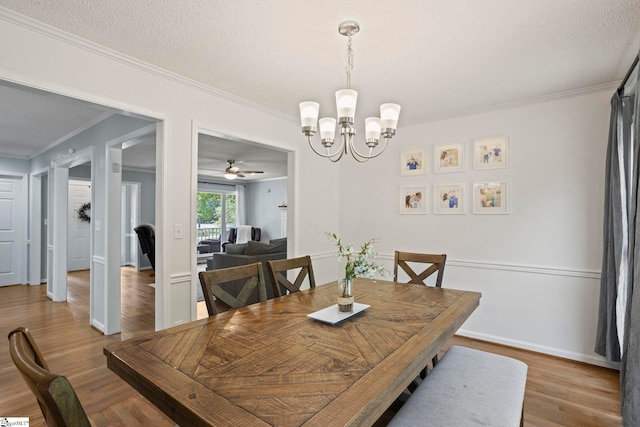 202 Shadow Oaks Dr, Easley, SC 29642 - dining room featuring a chandelier, crown molding, a ceiling fan, wood finished floors, and baseboards