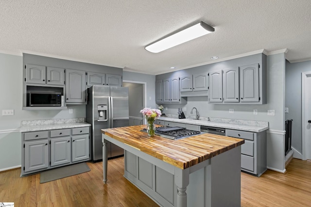 202 Shadow Oaks Dr, Easley, SC 29642 - kitchen featuring stainless steel appliances, gray cabinets, butcher block counters, ornamental molding, and a textured ceiling