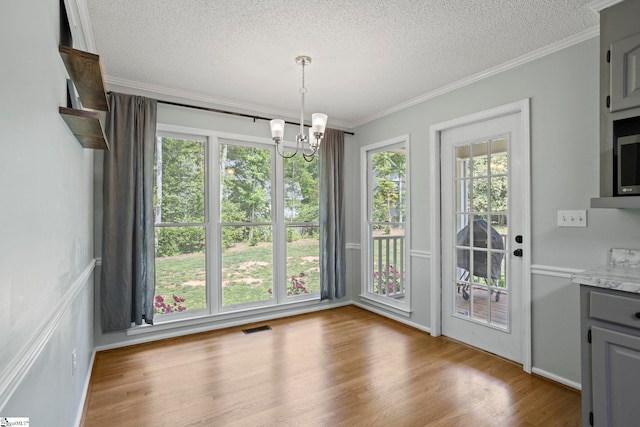 202 Shadow Oaks Dr, Easley, SC 29642 - unfurnished dining area with a textured ceiling, a chandelier, ornamental molding, and wood finished floors