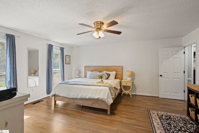 202 Shadow Oaks Dr, Easley, SC 29642 - bedroom with wood finished floors, a textured ceiling, baseboards, and a ceiling fan