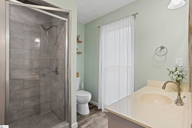 202 Shadow Oaks Dr, Easley, SC 29642 - bathroom featuring a shower stall, wood finished floors, toilet, a textured ceiling, and vanity