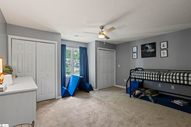 202 Shadow Oaks Dr, Easley, SC 29642 - carpeted bedroom with two closets, baseboards, ceiling fan, and a textured ceiling
