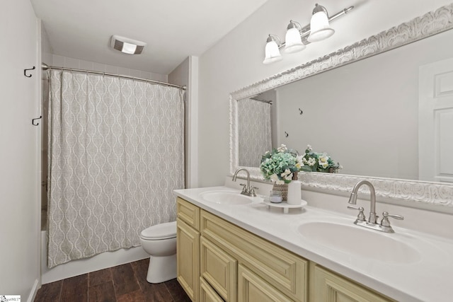 202 Shadow Oaks Dr, Easley, SC 29642 - bathroom featuring wood finished floors, toilet, double vanity, and shower / tub combo with curtain