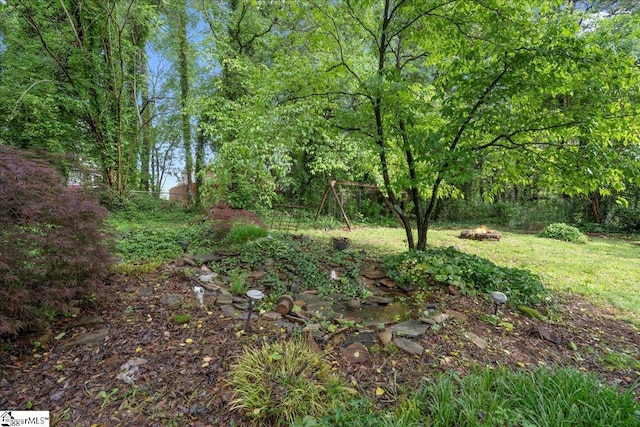 1606 Winding Way, Taylors, SC 29687 - view of yard with an outdoor fire pit and a view of trees