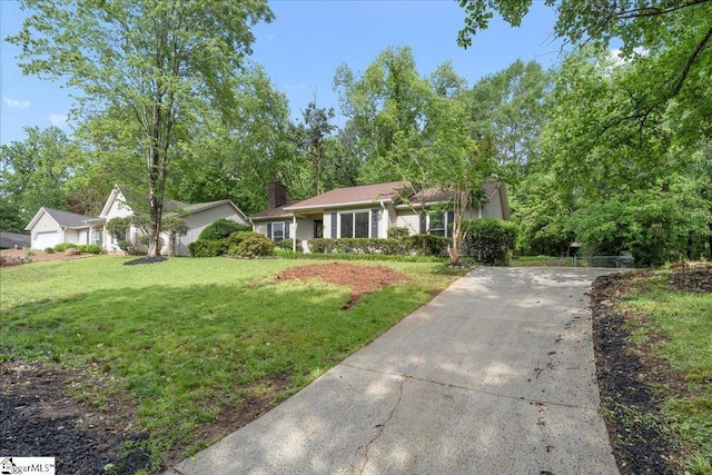 1606 Winding Way, Taylors, SC 29687 - view of front facade with concrete driveway, a front lawn, and a chimney