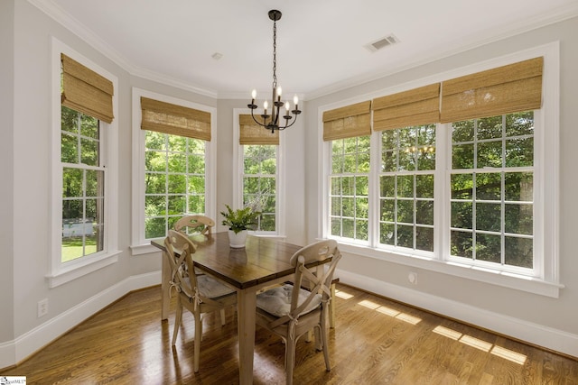 dining space with plenty of natural light, baseboards, and crown molding