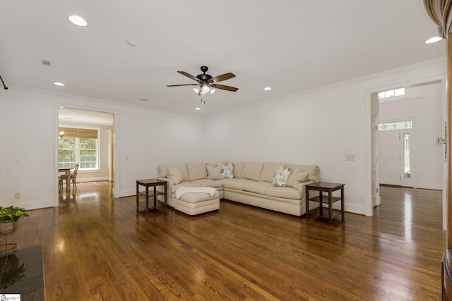 living room featuring baseboards, ornamental molding, wood finished floors, ceiling fan, and recessed lighting
