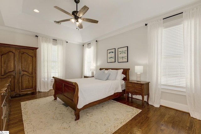 bedroom featuring dark wood-type flooring, a tray ceiling, a ceiling fan, baseboards, and recessed lighting