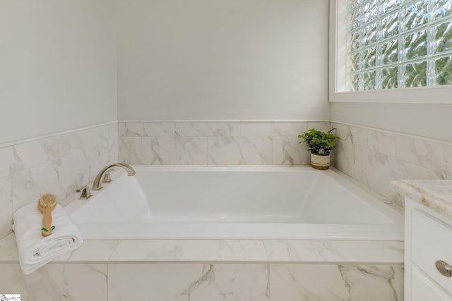 bathroom with a bath and vanity