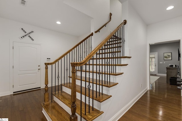 stairway with wood finished floors, recessed lighting, and baseboards