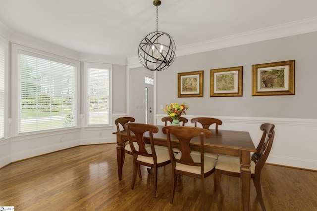 dining area with a chandelier, wood finished floors, crown molding, and baseboards