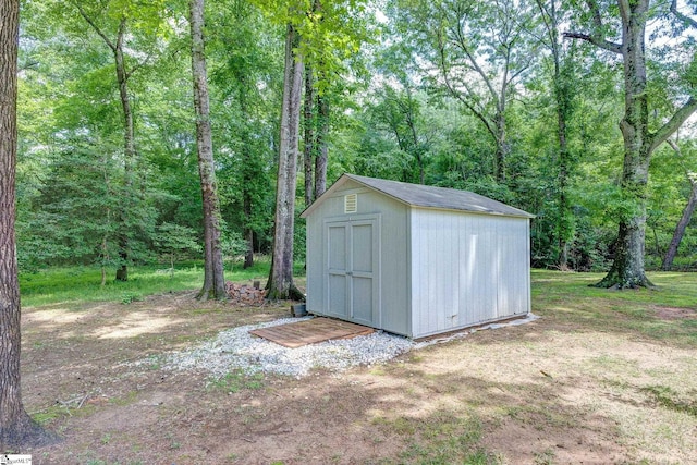view of shed with a view of trees