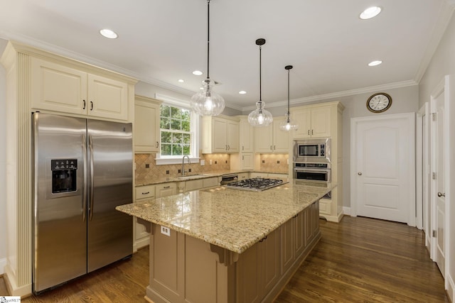 kitchen featuring stainless steel appliances, light stone countertops, a sink, backsplash, and crown molding