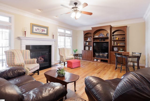 7 Collina Ct, Greenville, SC 29609 - living room with ornamental molding, a fireplace with flush hearth, a ceiling fan, and light wood finished floors
