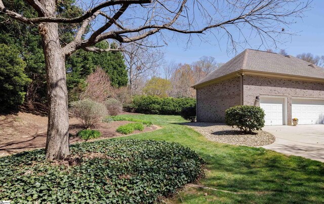 7 Collina Ct, Greenville, SC 29609 - view of grassy yard featuring concrete driveway and an attached garage