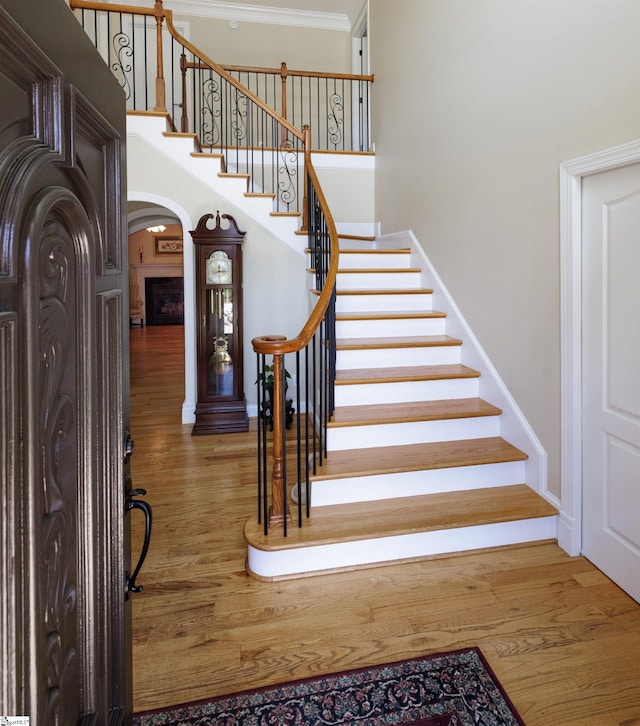 7 Collina Ct, Greenville, SC 29609 - staircase featuring arched walkways, baseboards, and wood finished floors