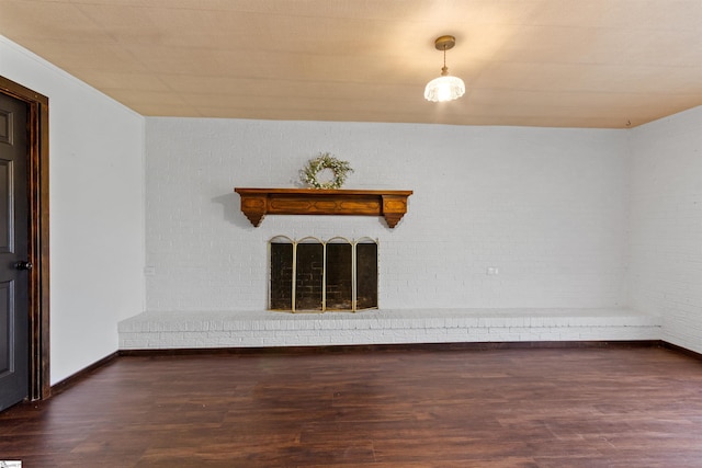 spare room with baseboards and wood finished floors